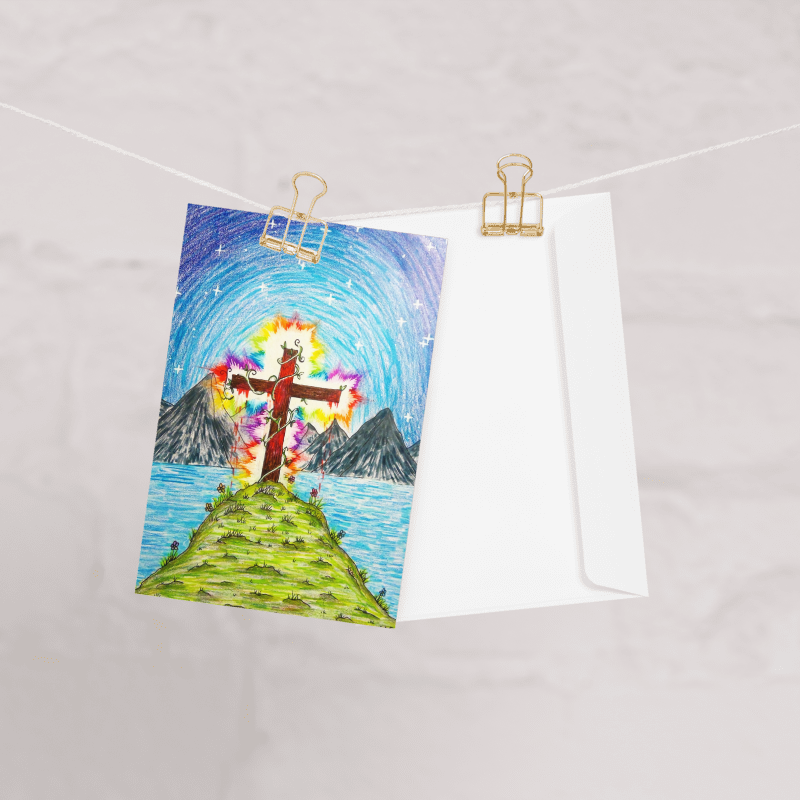 Colourful drawing of a cross on a mountain with a white envelope underneath, pinned to a string.