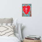 Heart-shaped artwork with a cross on a wall above a bed with pillows and books.
