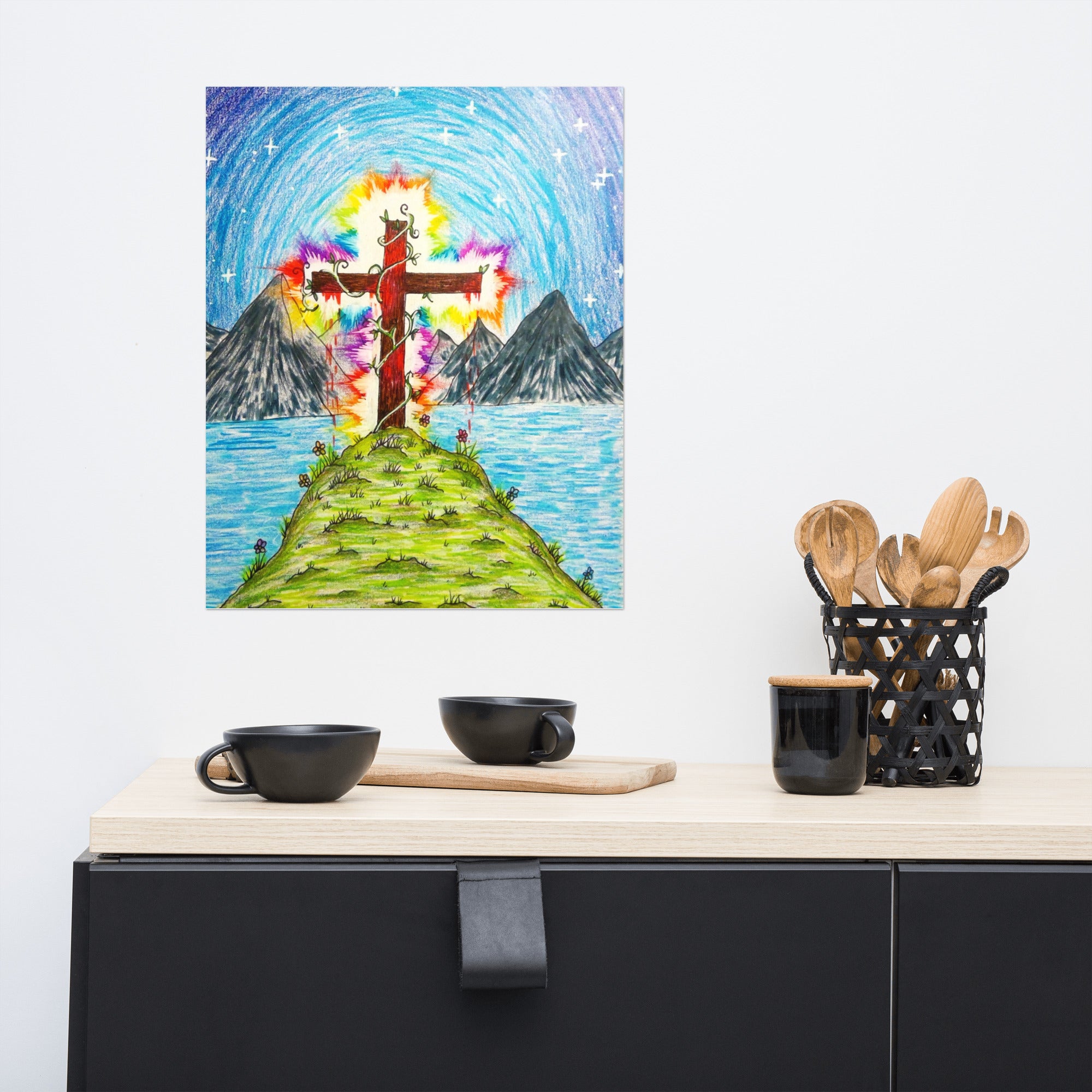 Colorful painting of a cross on an island with mountains in the background, displayed above a kitchen counter.