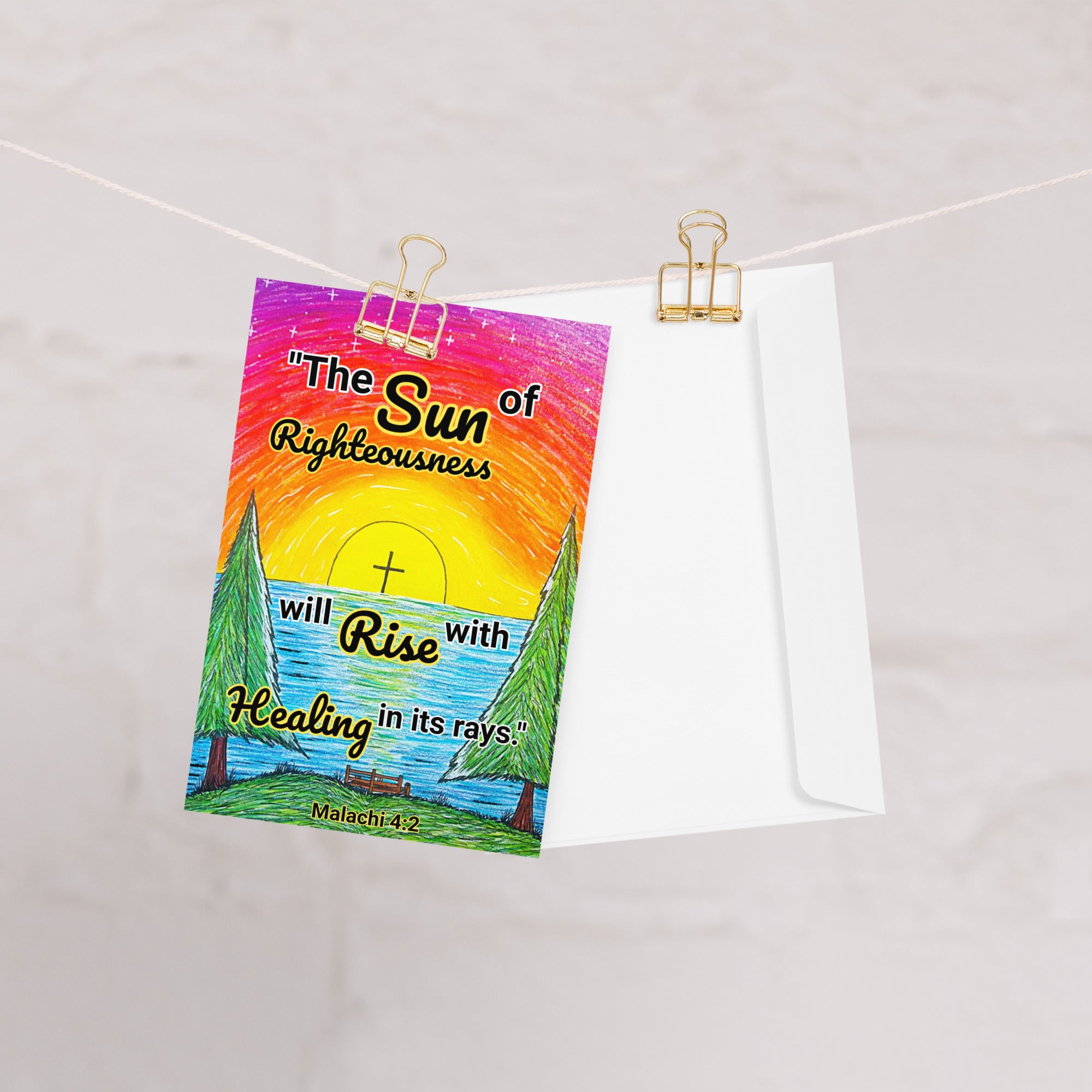 A greeting card with a sunrise design and text that says, "The sun of righteousness will rise with healing in its rays." -Malachi 4:2.