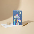 Glowing Mushrooms 5x7 greeting card featuring 3 glowing mushrooms with a rainy midnight background and moon – AllThingsGoode
