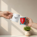 Two hands holding white mugs with one featuring a red heart design and cross, and the other with text 'Scripture Here'.
