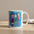 Mug with colorful illustration of three characters on a white background