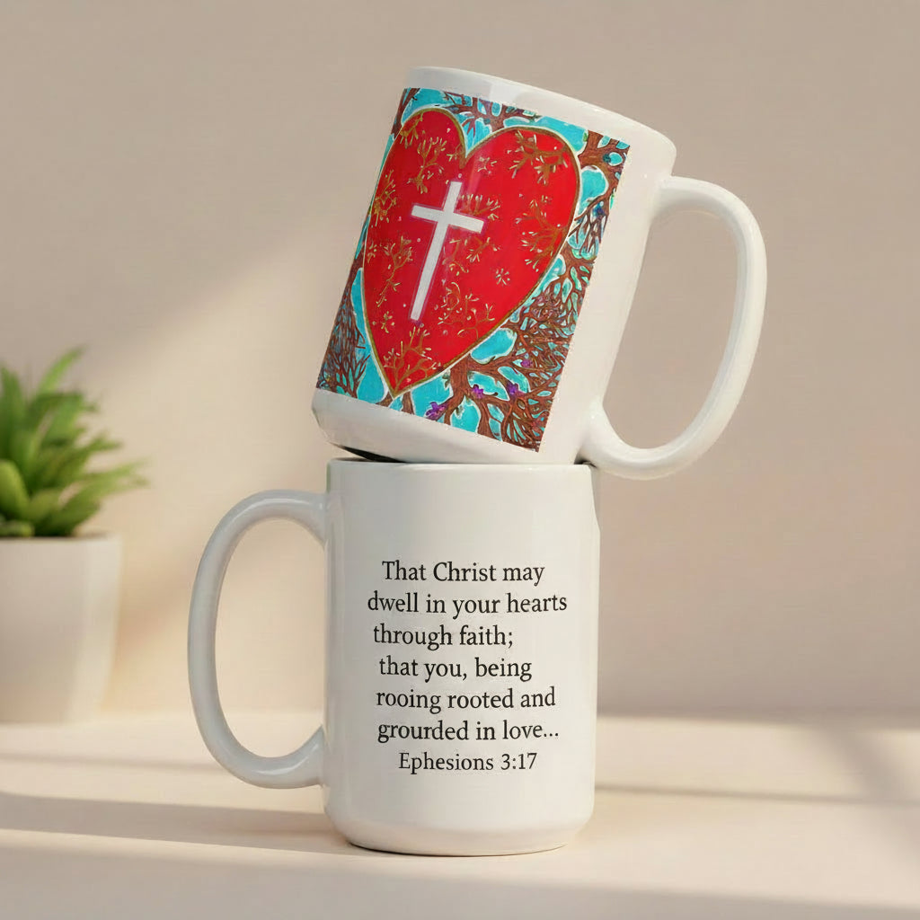 White mug with a colorful heart design and cross on top of another white mug with 'Ephesians 3:17' text.