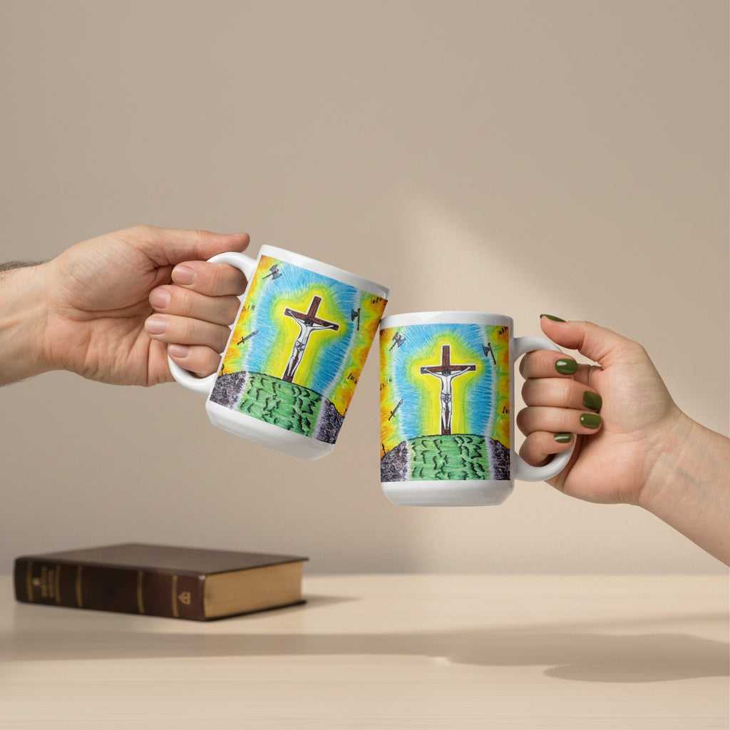 Two white ceramic mugs with a colorful illustration of a cross on a hill under a blue and yellow sky, held by two hands against a white background.