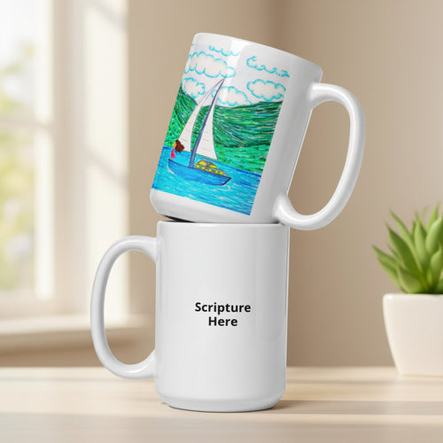 Two white ceramic mugs stacked on a white background. The top mug is tilted to show a colourful illustration of a sailboat on blue water with green hills and clouds.